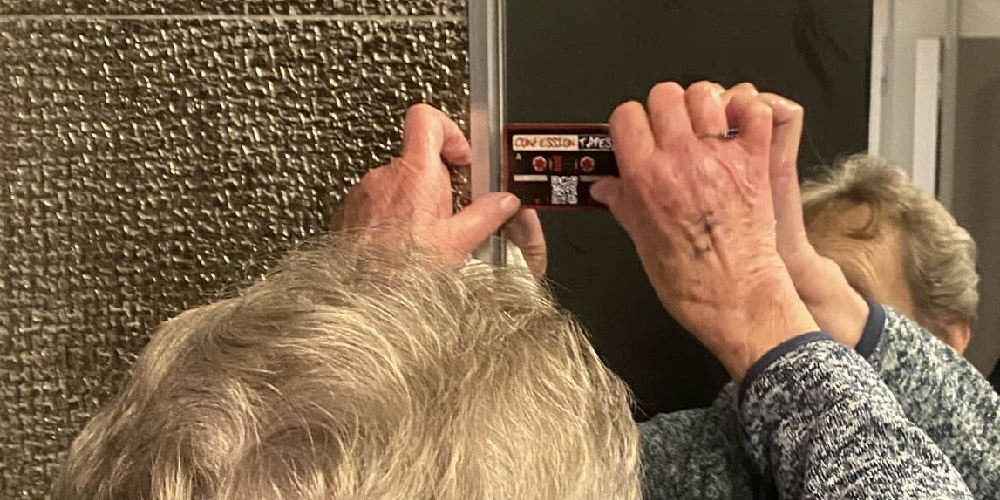 Picture of a grandma applying sticker onto a mirror.