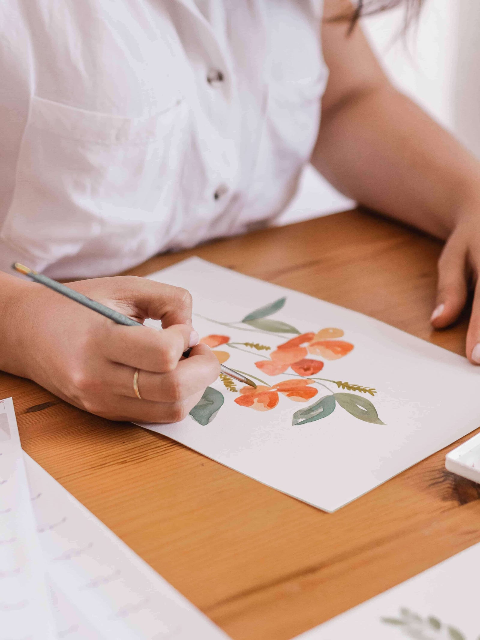 Watercolour artist creating designs on stickers