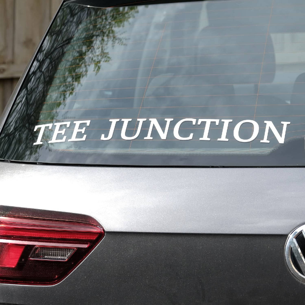 Tee Junction lettering sticker on a car rear windshield.