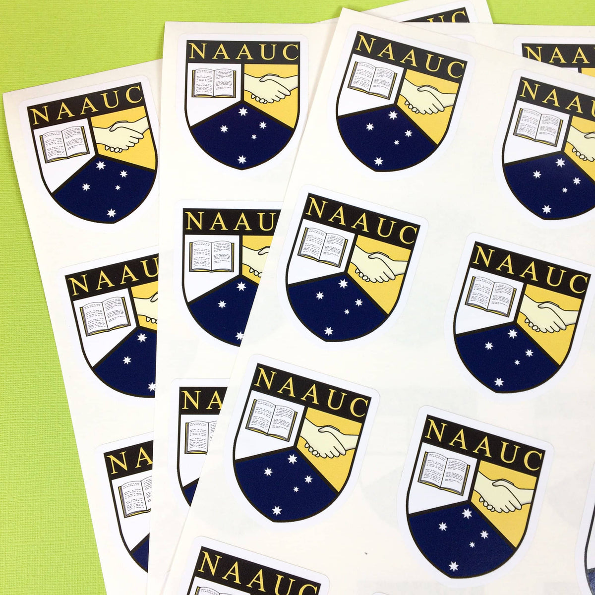National Association of Australian University Colleges logo custom cut stickers on a sheet.